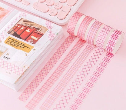 Colorful Grid Washi Tape Set in pink shades displayed with patterns, ideal for planners and DIY projects, shown with a decorated notebook and pastel keyboard in the background.