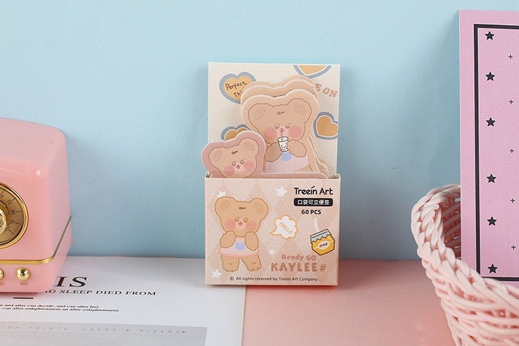 Milk Tea Weekend Sticky Notepad - 60 Pages Memo featuring cute bear illustrations in a kawaii style, displayed in a decorative box with pastel colors and surrounded by other stationery items.