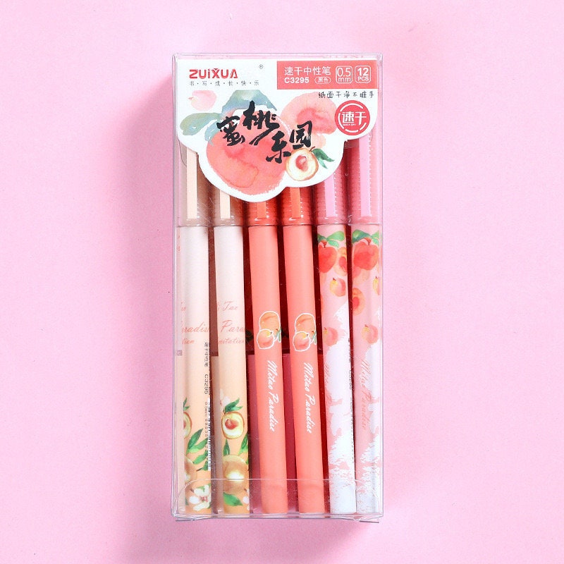 Peach Scented 0.5mm Kawaii Gel Pen set in assorted peach-themed designs packaged in a clear plastic box with pink background.