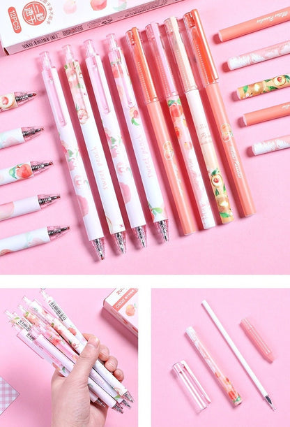 Peach scented 0.5mm kawaii gel pens with cute peach designs on pastel pink and white barrels, arranged on a pink background.