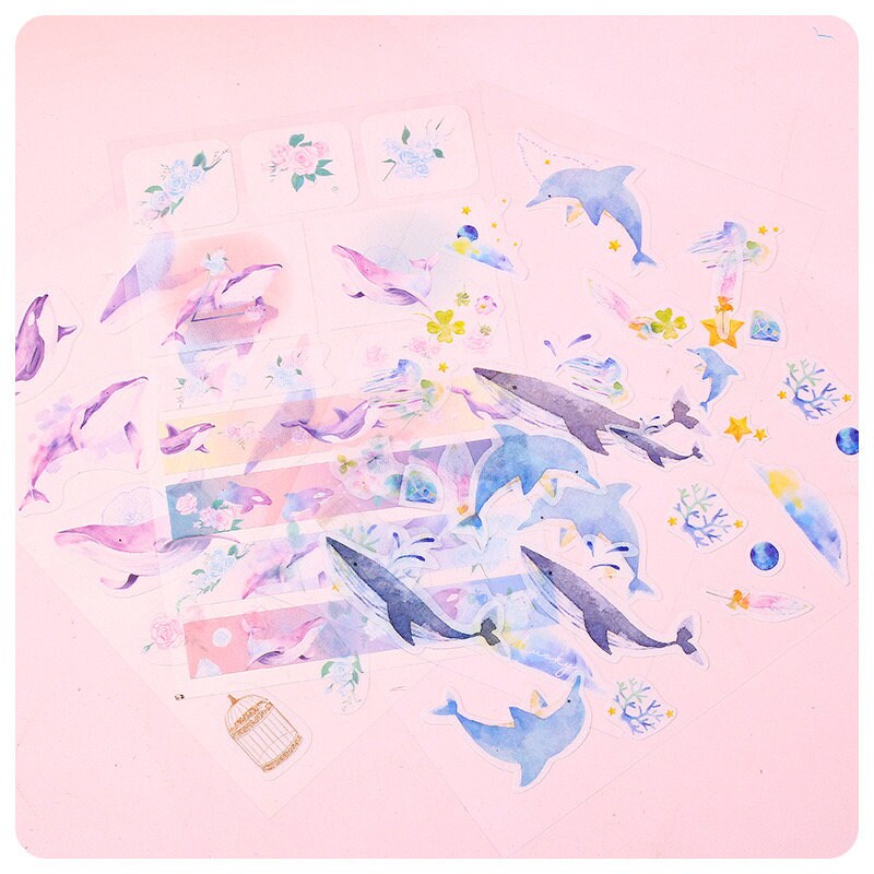 Kawaii Dolphin Ocean Stickers Set featuring 20 unique designs of adorable dolphins, ocean animals, and ocean-themed illustrations on a pink background. Perfect for decorating notebooks, planners, and scrapbooks with cute marine life stickers.