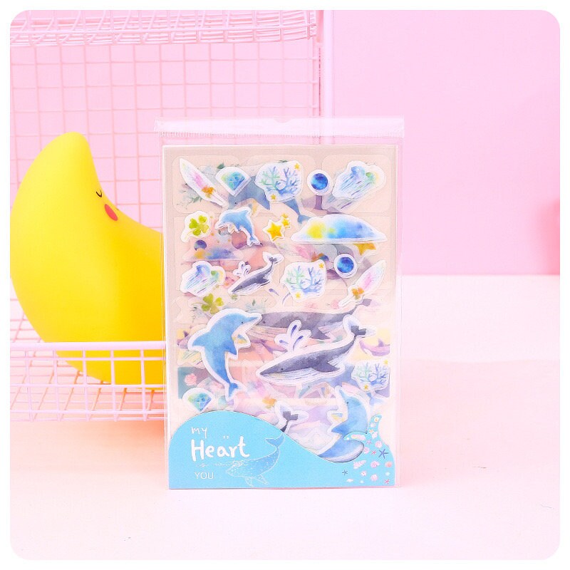 Kawaii Dolphin Ocean Stickers Set with 20 designs featuring cute dolphin and ocean-themed illustrations in a pastel color palette, perfect for scrapbooking and journaling.