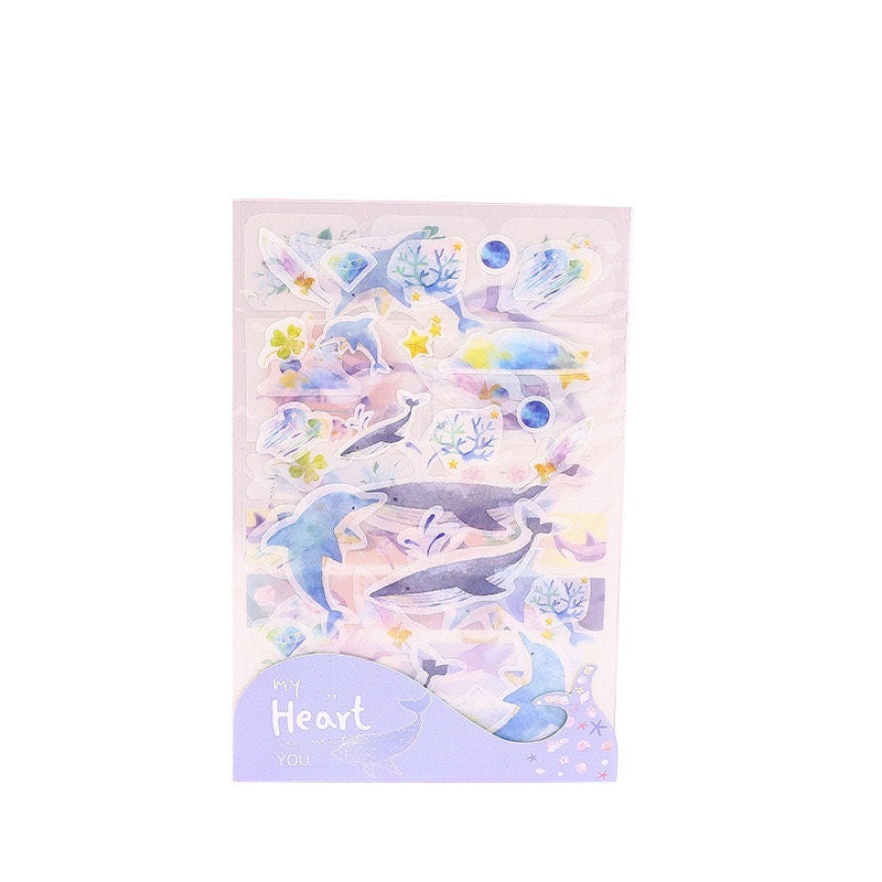 Kawaii Dolphin Ocean Stickers Set with 20 Designs, featuring adorable dolphins, sea creatures, and ocean-themed decorations in pastel colors. Perfect for scrapbooking, planners, and crafts.