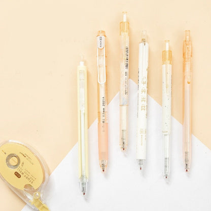 Kawaii Black Ink Gel Pens Set - 0.5mm with multiple pastel-colored pen casings placed on a light beige background, showcasing cute and stylish design, perfect for note-taking and journaling.