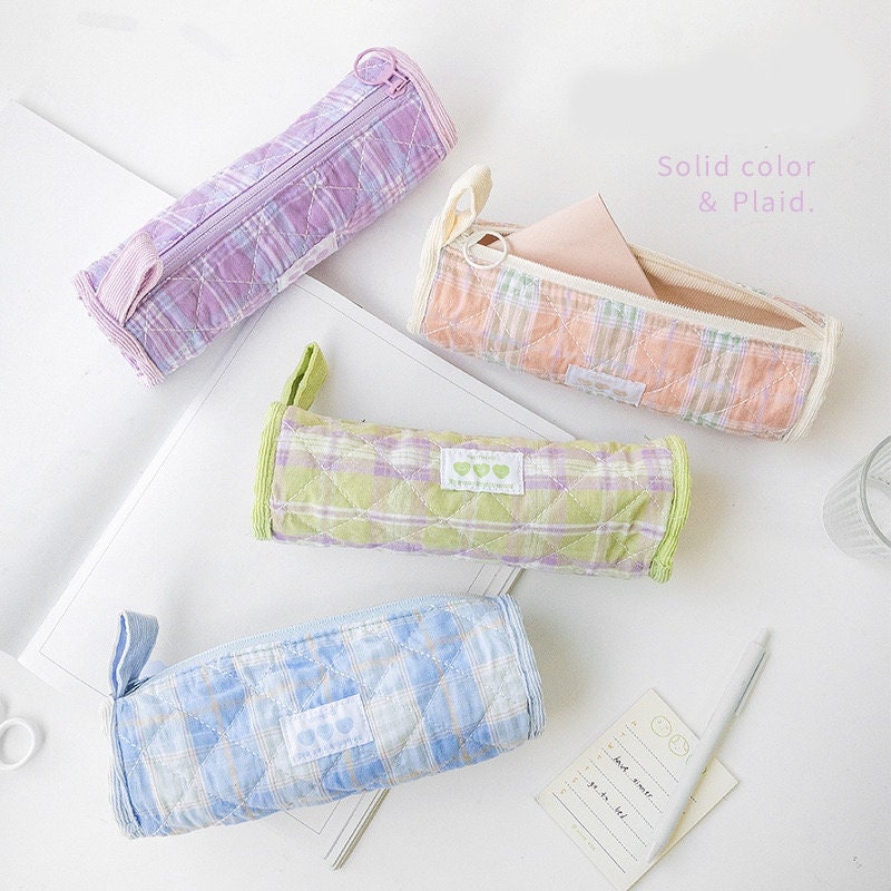 Double-sided milky cream fabric pencil case in pastel plaid design, available in purple, peach, green, and blue, perfect for storing stationery items in kawaii style.