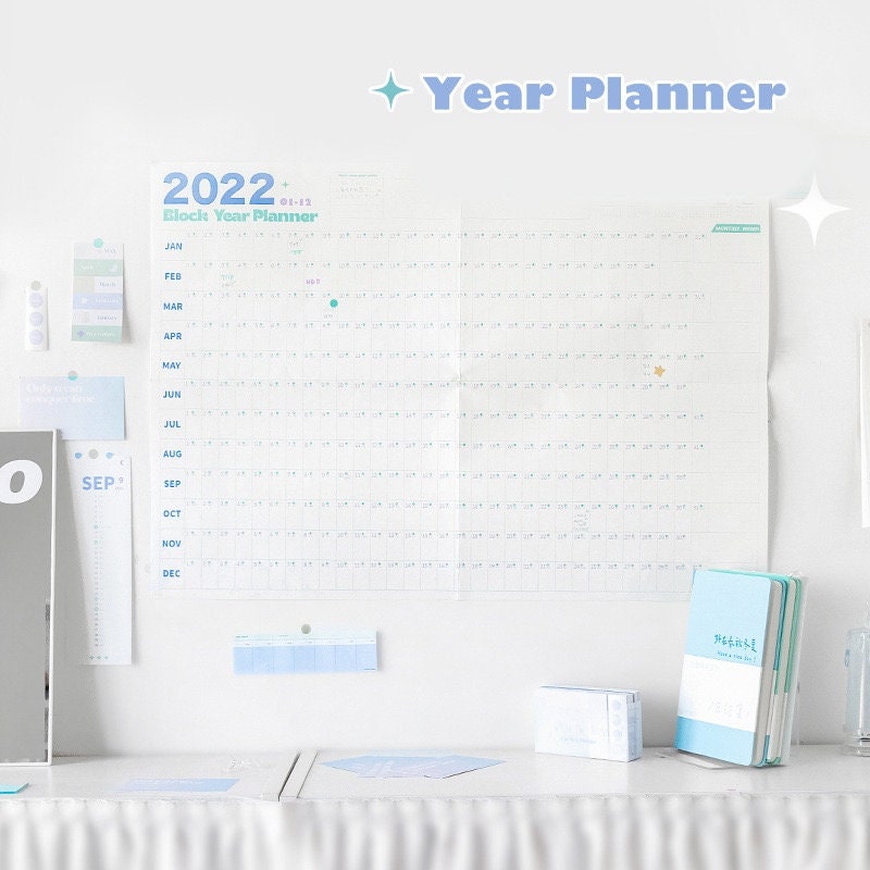 2022 Yearly Planner - Goal Tracker and Organizer, with monthly layouts, motivational stickers, and pastel-colored design. Ideal for personal, academic, or professional planning.