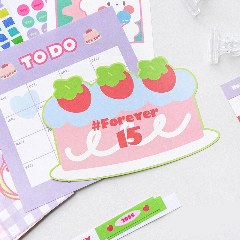 2022 Goal Tracker Calendar with Stickers in cute kawaii style, featuring a colorful To-Do list page, strawberry cake design, and decorative kawaii stickers.