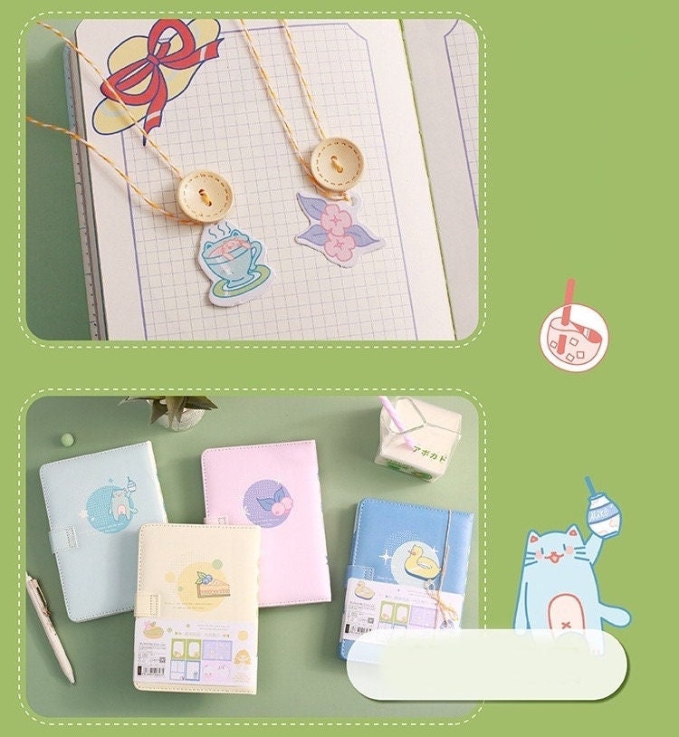 Magnetic Buckle A5 Hard Cover Summer Journal in pastel colors with cute kawaii designs displayed on green background.