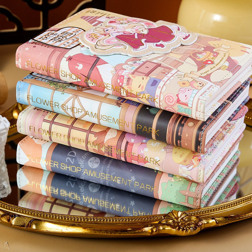 Stack of Blue Flower House Leather Journals in A6 size with 192 pages, featuring cute and colorful kawaii-style covers labeled "Flower Shop Amusement Park".