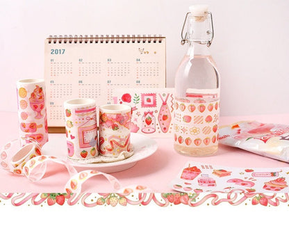 Strawberry Washi Tape Roll for Parties and Crafts, displayed with kawaii-style stationery on a pink surface, including decorative items and a 2017 calendar.