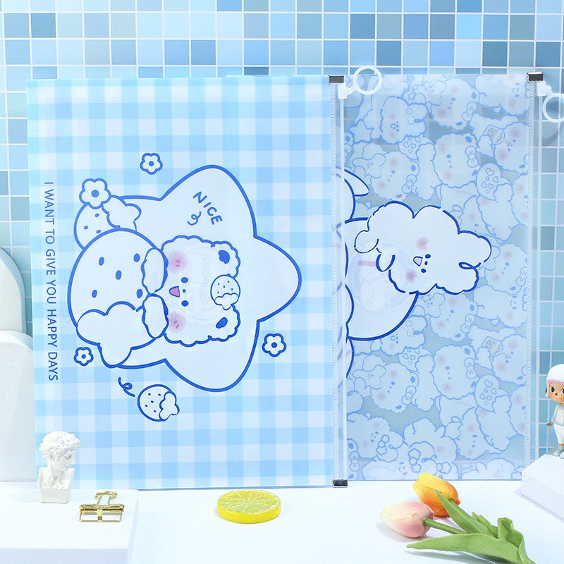 Kawaii Toffee Diary A4 Zip Document Bag with cute illustrated characters on blue checkered and cloud-patterned backgrounds, featuring text "I WANT TO GIVE YOU HAPPY DAYS". Ideal for storing documents, stationery, and school supplies.