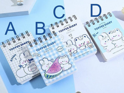 Toffee Diary Decorative Sticky Notepad Memo Pad in four kawaii designs labeled A through D. Features adorable illustrations of white fluffy animals on spiral-bound notepads. Perfect for cute stationery collections and adding a touch of kawaii to your notes.