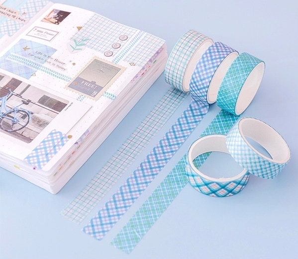 Colorful Grid Washi Tape Set in blue and teal tones, perfect for planners and DIY projects, shown applied in a notebook with different grid patterns.