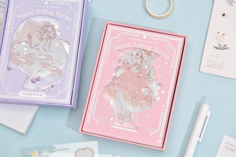 Magical Silver Foil Stickers for Planners and Crafts featuring kawaii character designs in pink and purple packaging, ideal for decorating journals, diaries, and scrapbooks.