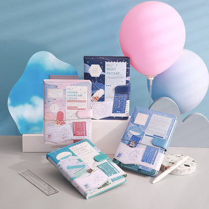 Island Cruise Magnetic Buckle Journal with Metal Bookmark in assorted colors and designs displayed with pastel balloons and stationery accessories.