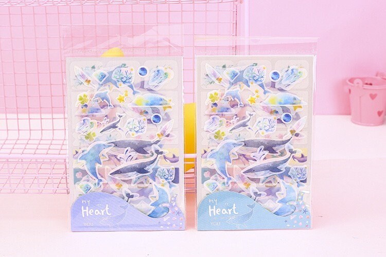 Kawaii Dolphin Ocean Stickers Set - 20 Designs in packaging, featuring adorable dolphin and marine-themed stickers in pastel colors.