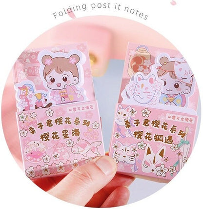 Kawaii girl sticky notepad with 60 pages, featuring cute pink pastel designs with characters in traditional Japanese outfits, cherry blossoms, and playful animals. Folding post-it notes ideal for memos and reminders.