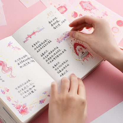 Hands decorating a journal with Dream Star Silver Foil Washi Sticker Set. Kawaii stationary, cute illustrations, and silver foil accents used for journaling.