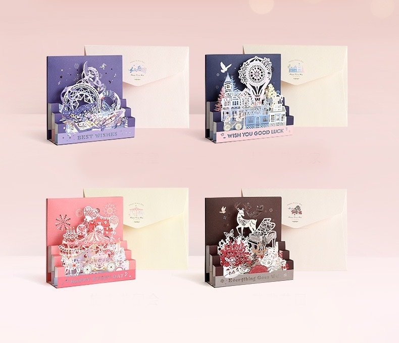 Starlight Studio Pop Up 3D Greeting Card set featuring intricate cut-out designs including a purple "Best Wishes" card, a blue "Wish You Good Luck" card, a pink "Happy Every Day" card, and a brown "Everything Goes Well" card, each with matching envelopes.