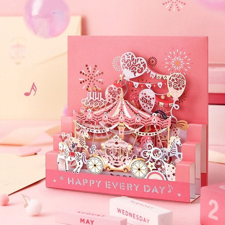 Starlight Studio Pop Up 3D Greeting Card with carousel and heart balloon designs, "Happy Every Day" message, pink and pastel colors, intricate details, perfect for birthdays and celebrations, kawaii stationary.