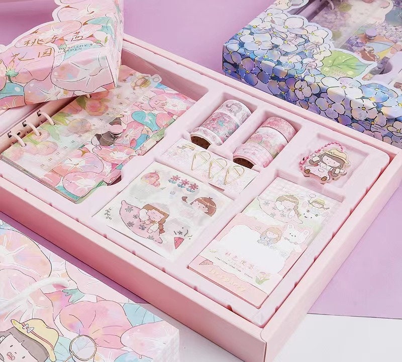 Dorothy Planner Gift Set in kawaii style including a journal, stickers, washi tape, and decorative paper clips, all featuring adorable pastel designs and cute characters. Perfect for journaling, planning, and scrapbooking.