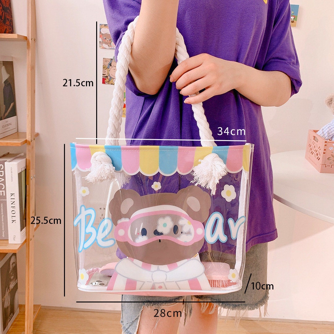 Clear vinyl tote bag with cute animal design, featuring colorful striped top and white rope handles, perfect for kawaii fashion lovers.