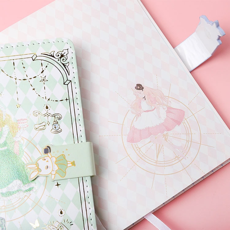 Alice Dream Journal with gold foil leather cover featuring pastel green and white pattern, cute bunny clasp, and whimsical Alice illustration inside.