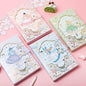 Alice Dream Journal - Gold Foil Leather Cover featuring four pastel colored notebooks decorated with Alice in Wonderland themed illustrations and charming kawaii designs, placed on a pink background with doily lace decorations and a small cute cake.