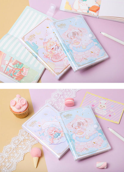 Lolita PVC Buckle Notebook with 224 pages, A5 journal featuring cute pastel illustrations, arranged with decorative lace, a pink macaron, a cupcake, and kawaii stationery on a pink and yellow background.