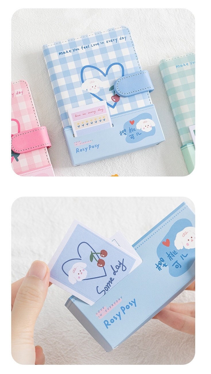 Magnetic Buckle Leather Grid Planner Blue A6 Notebook with cute cherry and heart design, "Rosy Posy" branding, and colorful inserts. Featured image showcases the detailed illustrations and magnetic closure. Ideal for kawaii stationary collectors.