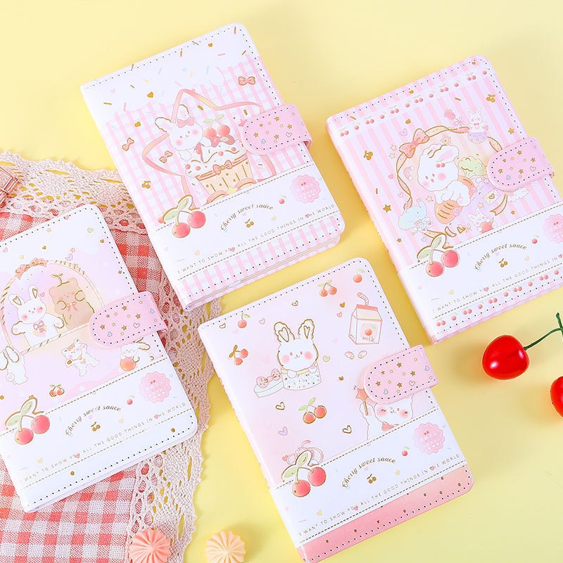 Pink Cherry Sauce A6 Journal with Magnetic Buckle featuring kawaii bunny and cherry designs, set of four on pastel background, cute stationery