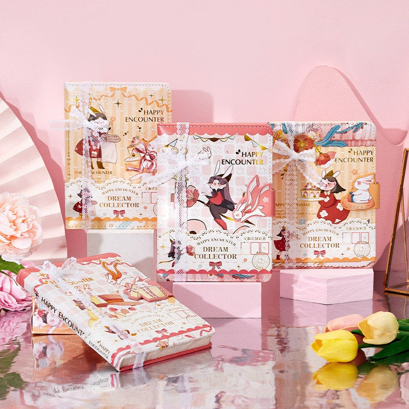 Dream Collector Magnetic Leather Notebook with Bookmark featuring kawaii illustrations and decorative lace ribbons, displayed amongst pink and yellow flowers.