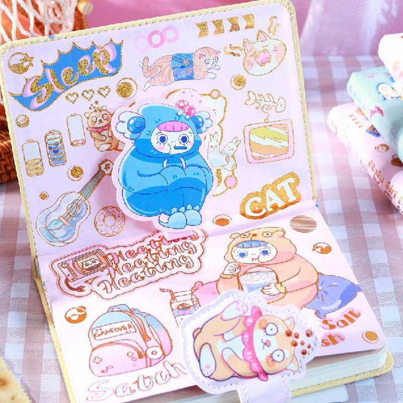 Otaku Girl Leather Journal with 3D Pages featuring kawaii illustrations, colorful cat and character stickers, and decorative 3D elements. Perfect for anime and manga fans, unique stationery gift.