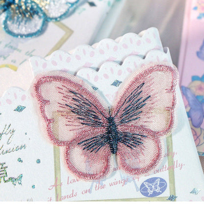 Butterfly Fairyland Leather Journal with Bookmark featuring a detailed pink and black embroidered butterfly design.