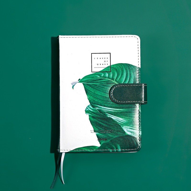 Tropical Leaf Journal with green leather cover and magnetic buckle featuring a vibrant leaf design.