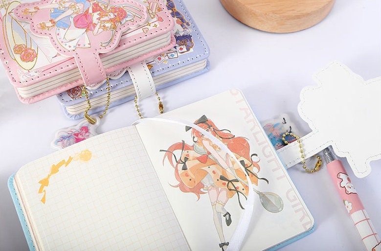 Kawaii A6 Shining Girl Leather Journal with Bookmark featuring adorable illustrations, pastel pink and purple covers, and a cute bookmark accessory.