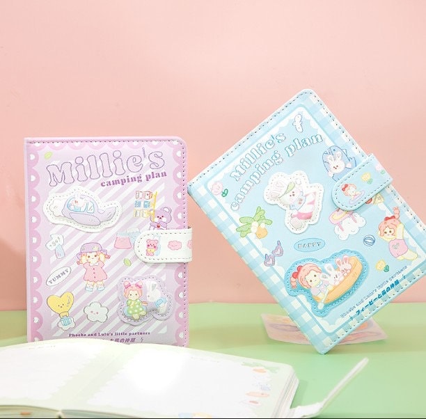 Millie's Leather Camping Journal with colorful pages in kawaii style, featuring adorable cartoon campers on purple and blue covers