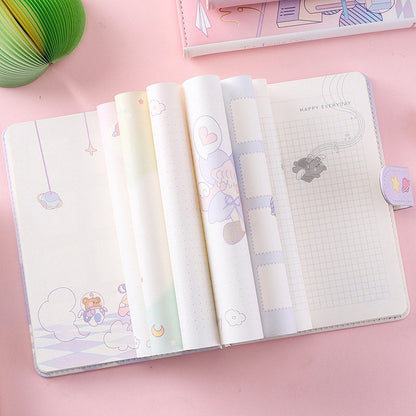 Kawaii Anime Leather Planner - Magic Girl Design Opened to Show Cute Pastel Inside Pages with Soft Illustrations and Grid Patterns on Pastel Pink Background