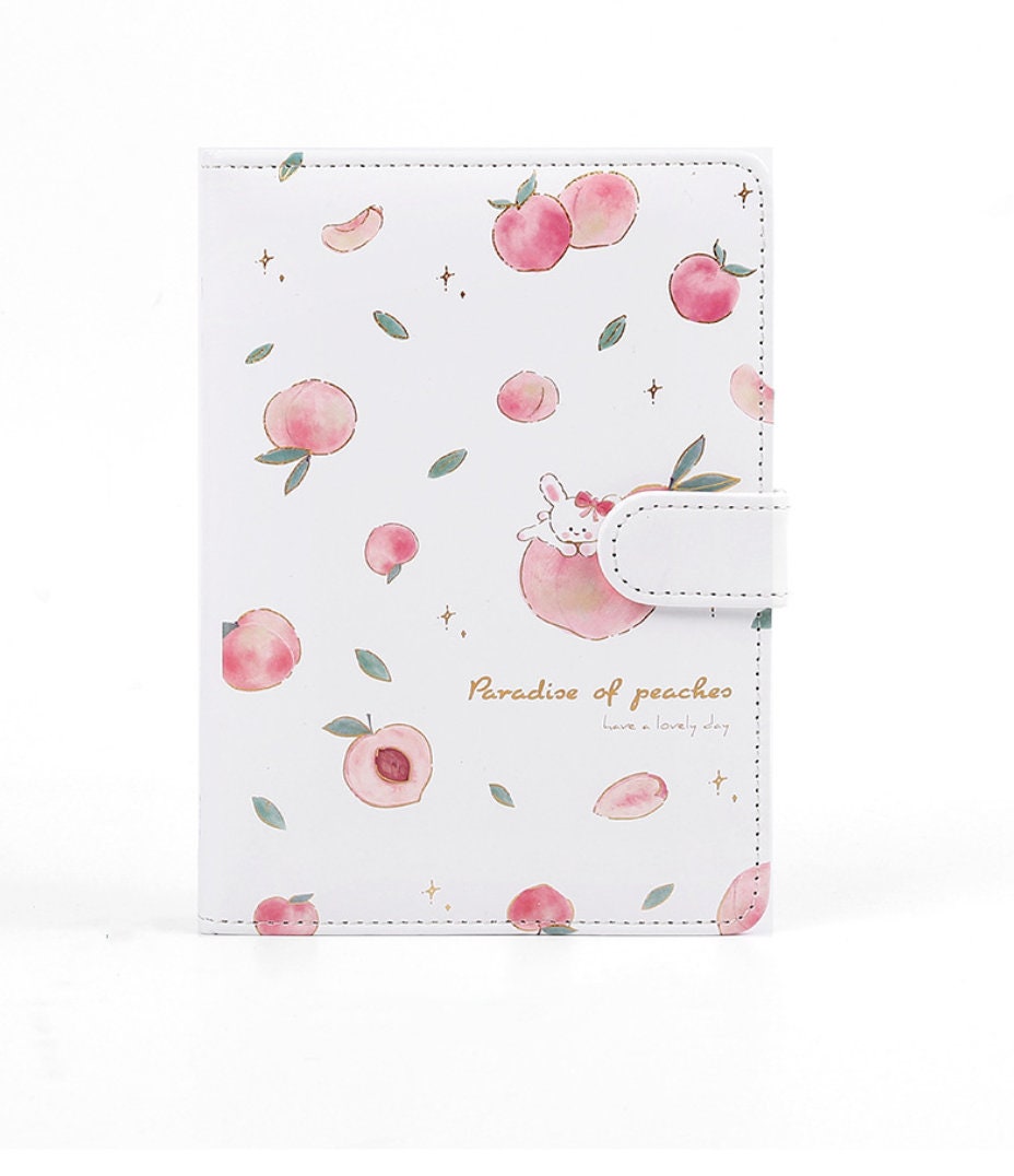 Peach Leather Planner in pink A5 size with 228 pages, magnetic closure, adorned with cute peach illustrations and a bunny, perfect for kawaii stationery lovers.