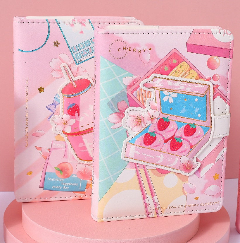 Pink Dessert Leather Journal with Magnetic Buckle featuring kawaii dessert illustrations, strawberries, cherry blossoms, and pastel colors. Perfect for writing, drawing, or as a cute stationery gift.