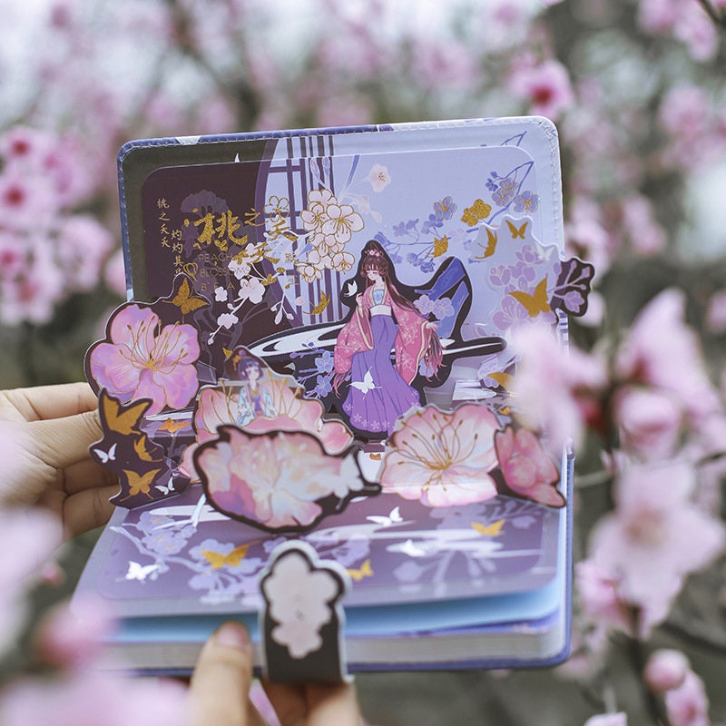 Peach Tree Elf Leather Planner with Butterfly Bookmark featuring intricate illustrations of a mystical elf in a vibrant pink and purple dress, surrounded by blooming flowers and butterflies. The planner showcases a whimsical design perfect for kawaii stationery lovers.