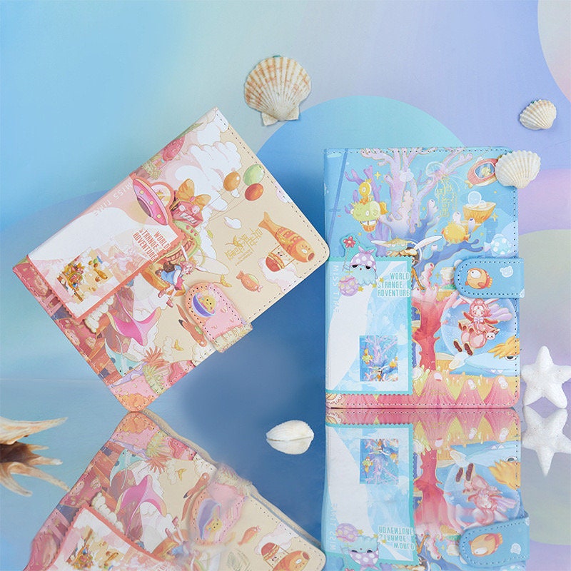 Strange World Adventure Journal with 3D pages and bookmark featuring colorful, whimsical illustrations on the cover, set against a pastel background with seashell accents.