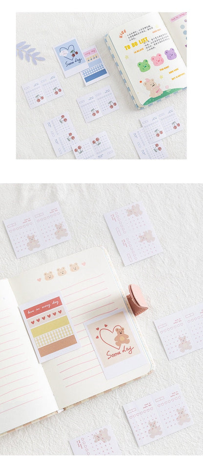 Magnetic Buckle Leather Grid Planner Blue A6 Notebook open with cute bear-themed stickers and to-do lists, featuring colorful pages and kawaii-style design elements