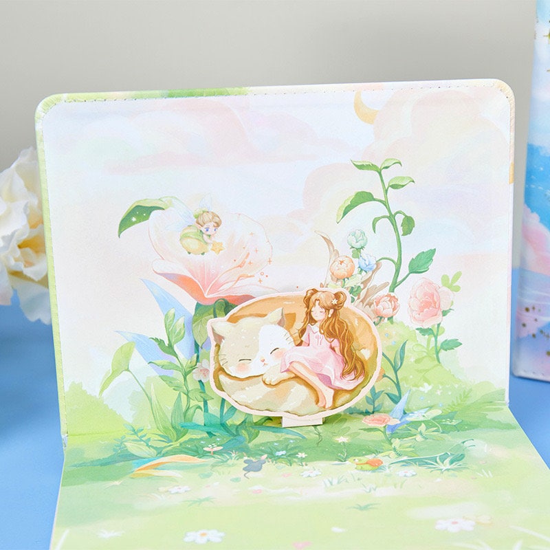 Peach leather journal with bookmark and 3D pages featuring an enchanting illustration of a girl sleeping with a cat in a magical garden.