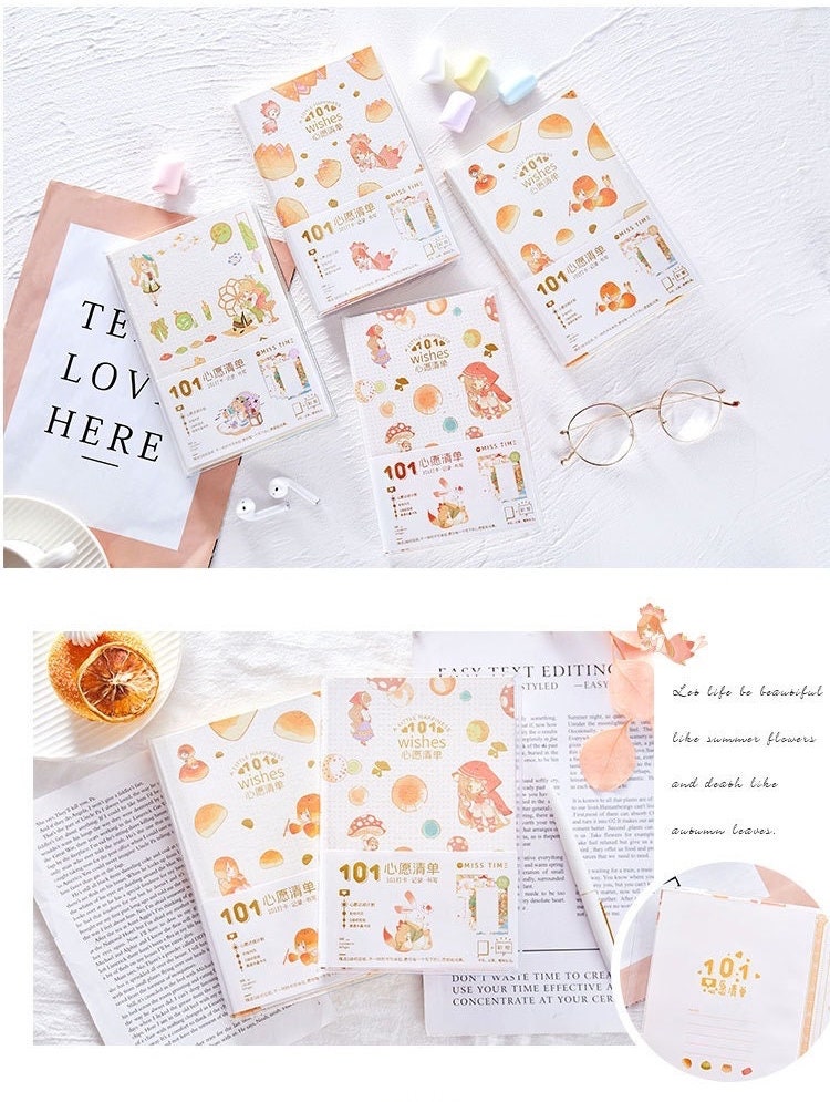 Once Upon a Time Crystal Cover Journal with cute and whimsical designs, displayed on a white desk with decorative items, eyeglasses, and additional stationery supplies.