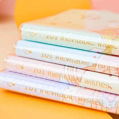 Stack of four colorful "Orange Star Crystal Cover Journal - 192 Pages" with gold text "101 inevitable wishes" embossed on spines.