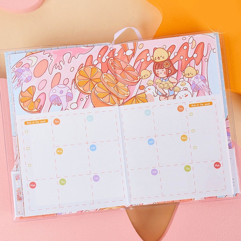 Orange Star Crystal Cover Journal - 192 Pages, open to a colorful weekly planner page with cute orange and character illustrations in kawaii style.