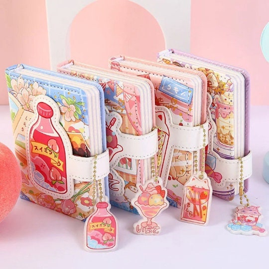 Kawaii A6 leather journal with magnetic buckle and bookmark, available in colorful, cute designs with adorable hanging charms.