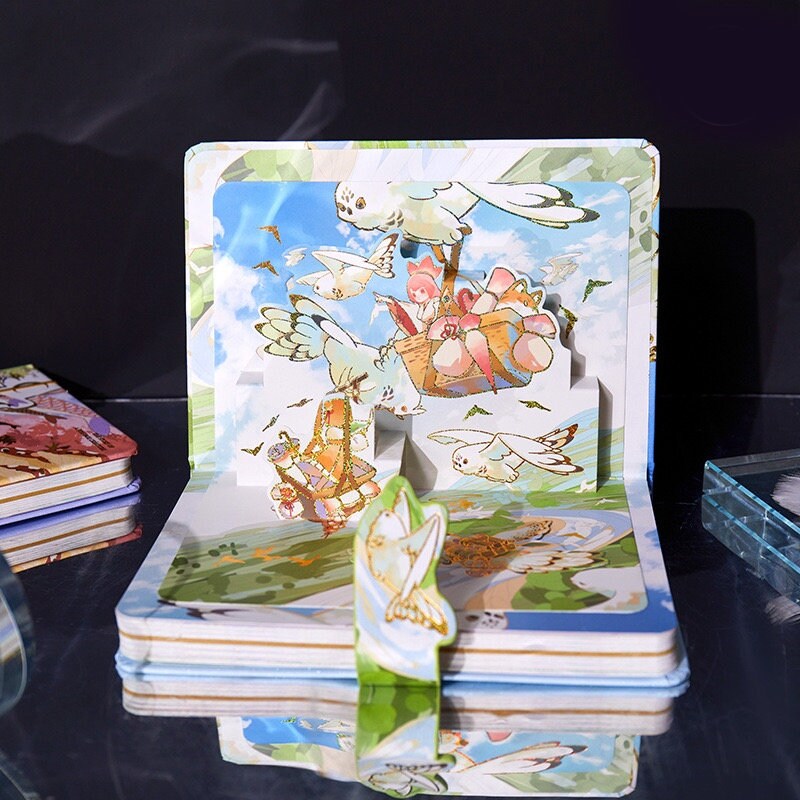 Anime hard cover journal with colorful pop-up scenery and metal bookmark, featuring flying birds and whimsical characters, perfect for kawaii stationery lovers.