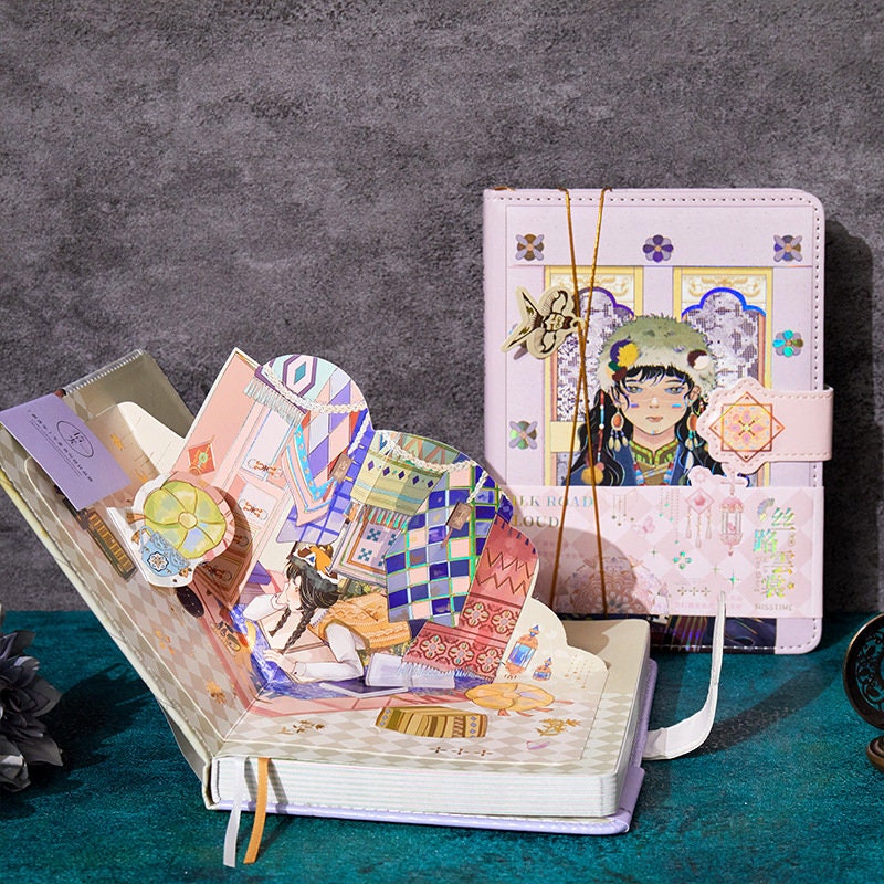 Silk Cloud Leather Journal with Bookmark - Magnetic Buckle in kawaii style, featuring intricate illustrations inside the pages and a decorated cover with a character design and geometric patterns.